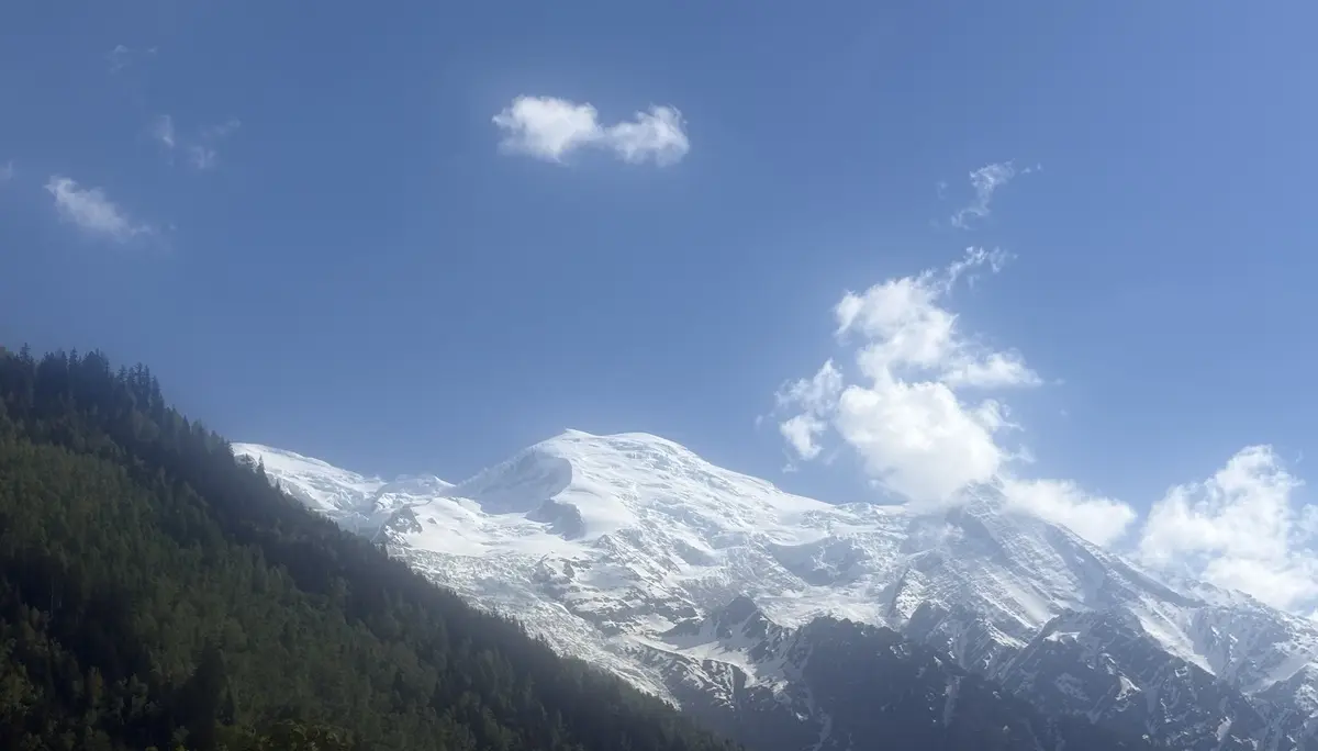 Schneebedeckte Berggipfel mit bewaldeten Hängen unter blauem Himmel mit einzelnen Wolken | © DAV-FN / R. Gersten