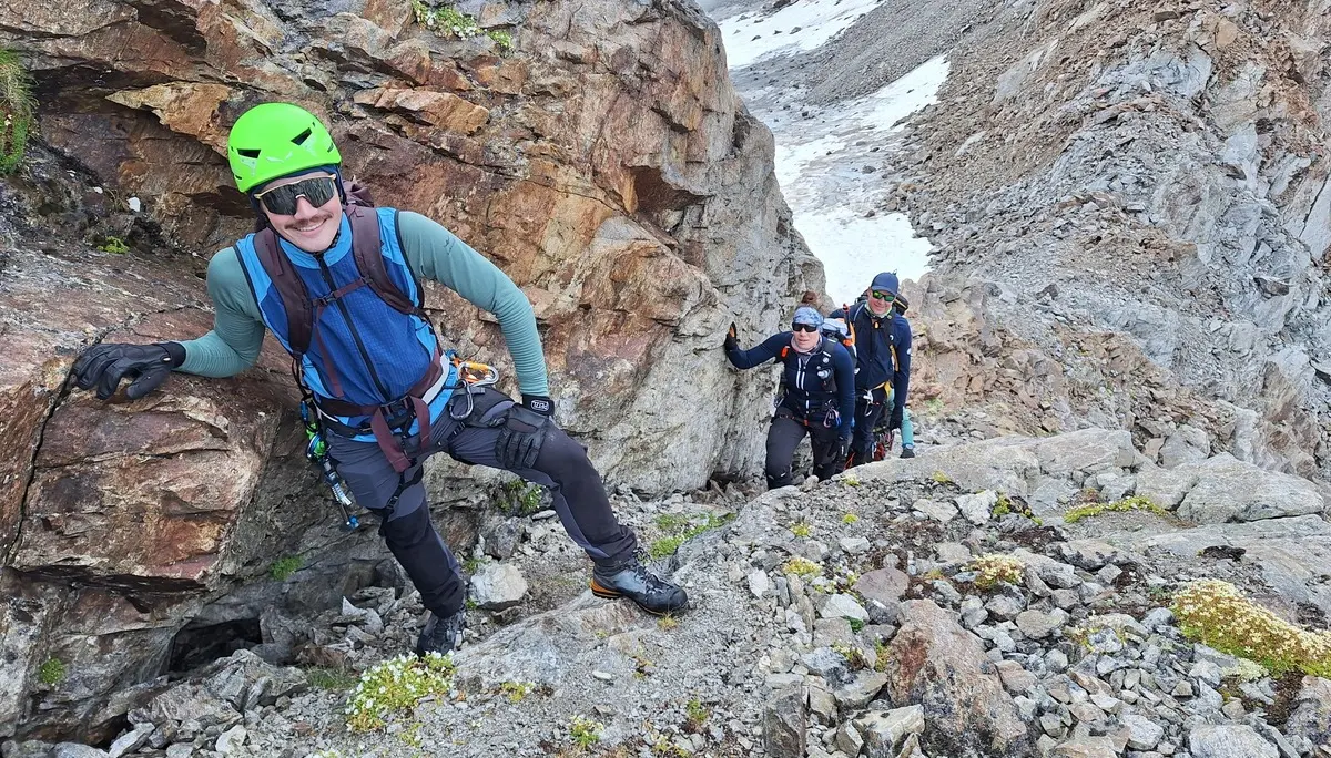 Drei Bergsteiger mit Kletterausrüstung steigen an einem felsigen Berghang auf | © Dav-Fn / R. Huber