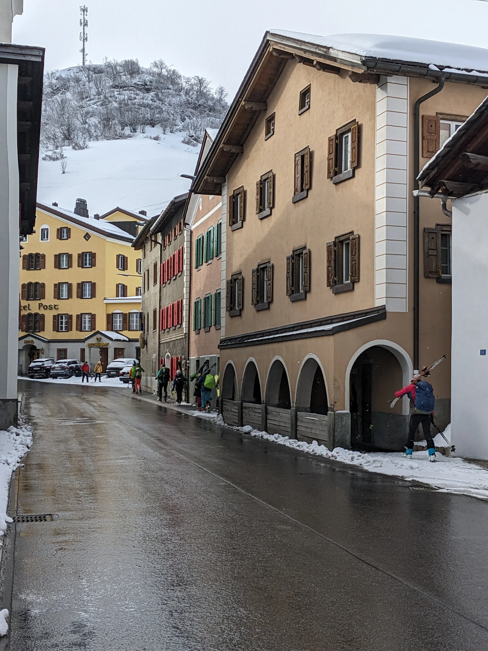 Skitourengeher tragen ihre Skier durch die Straßen von Bivio | © DAV-FN / Rucksack